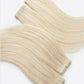 Beige hair extensions on a white background